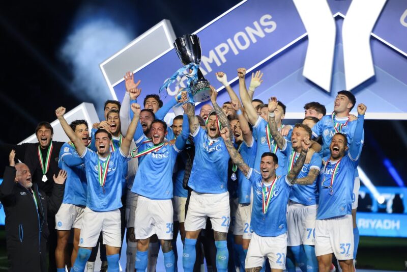 Napoli's Italian defender #22 Giovanni Di Lorenzo lifts the trophy on the podium after the Italian Super Cup final match between SCC Napoli and Bologna at King Al-Awwal Park Stadium in Riyadh on December 22, 2025. (Photo by Fayez NURELDINE / AFP)