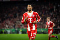 MUNICH, GERMANY - FEBRUARY 11: Close up of Michael Olise of FC Bayern Muenchen smiling during the DFB Cup Quarter Final match between FC Bayern München and RB Leipzig at Allianz Arena on February 11, 2026 in Munich, Germany. (Photo by S. Mellar/FC Bayern via Getty Images)
